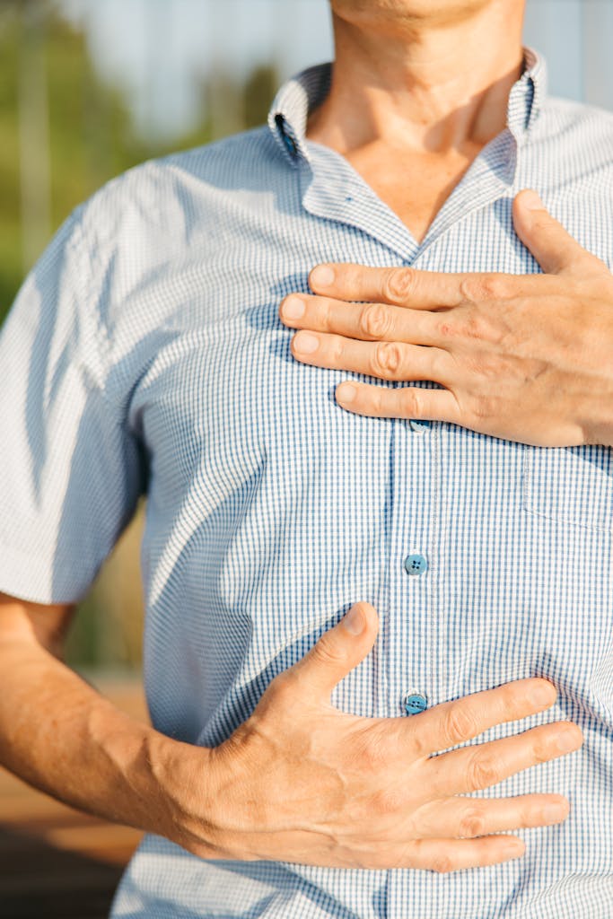 Man Holding His Stomach and Chest